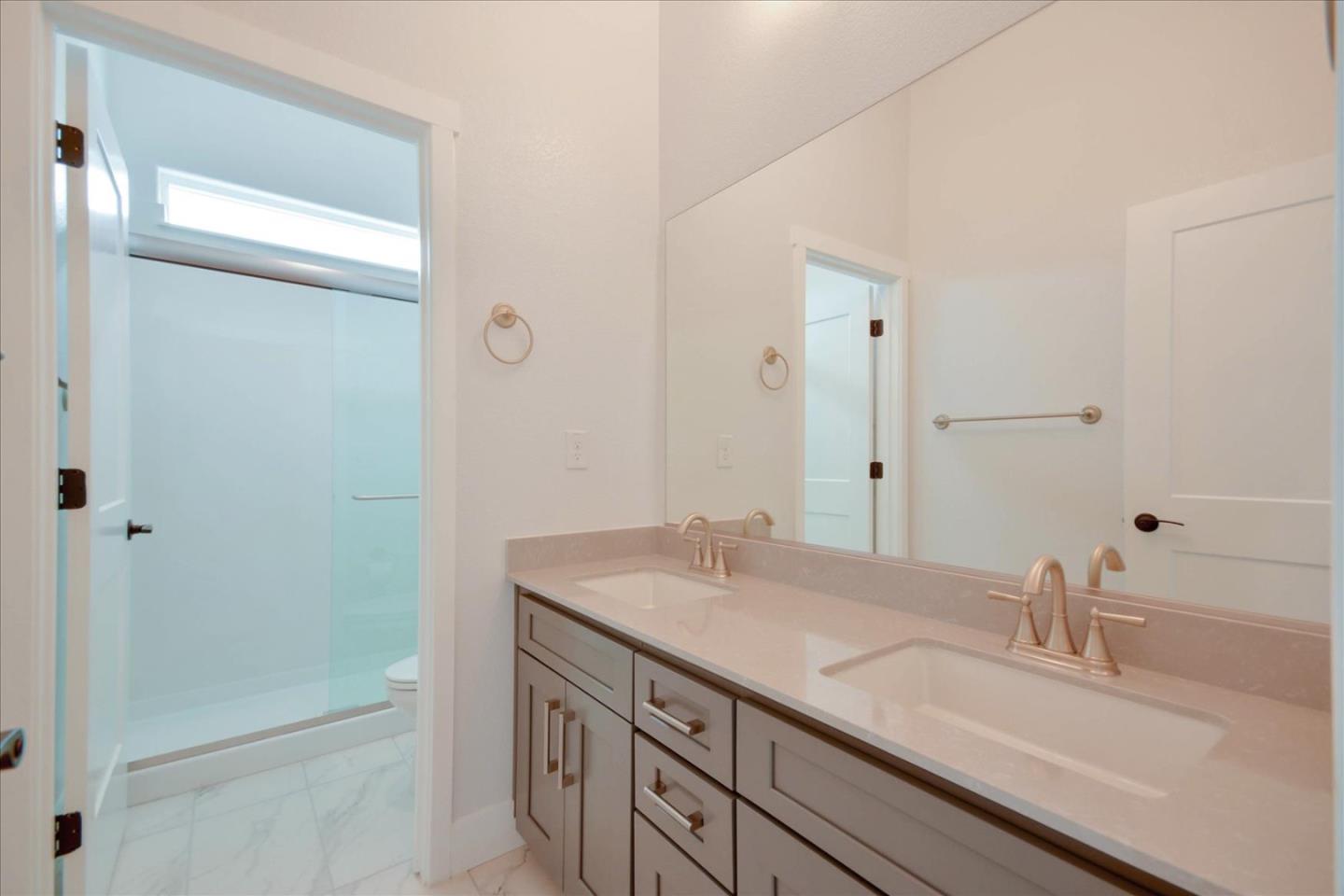 8157 Poppy Ridge Road Elk Grove, CA 95757 - Photo 27 of 42 a bathroom with a sink and a mirror