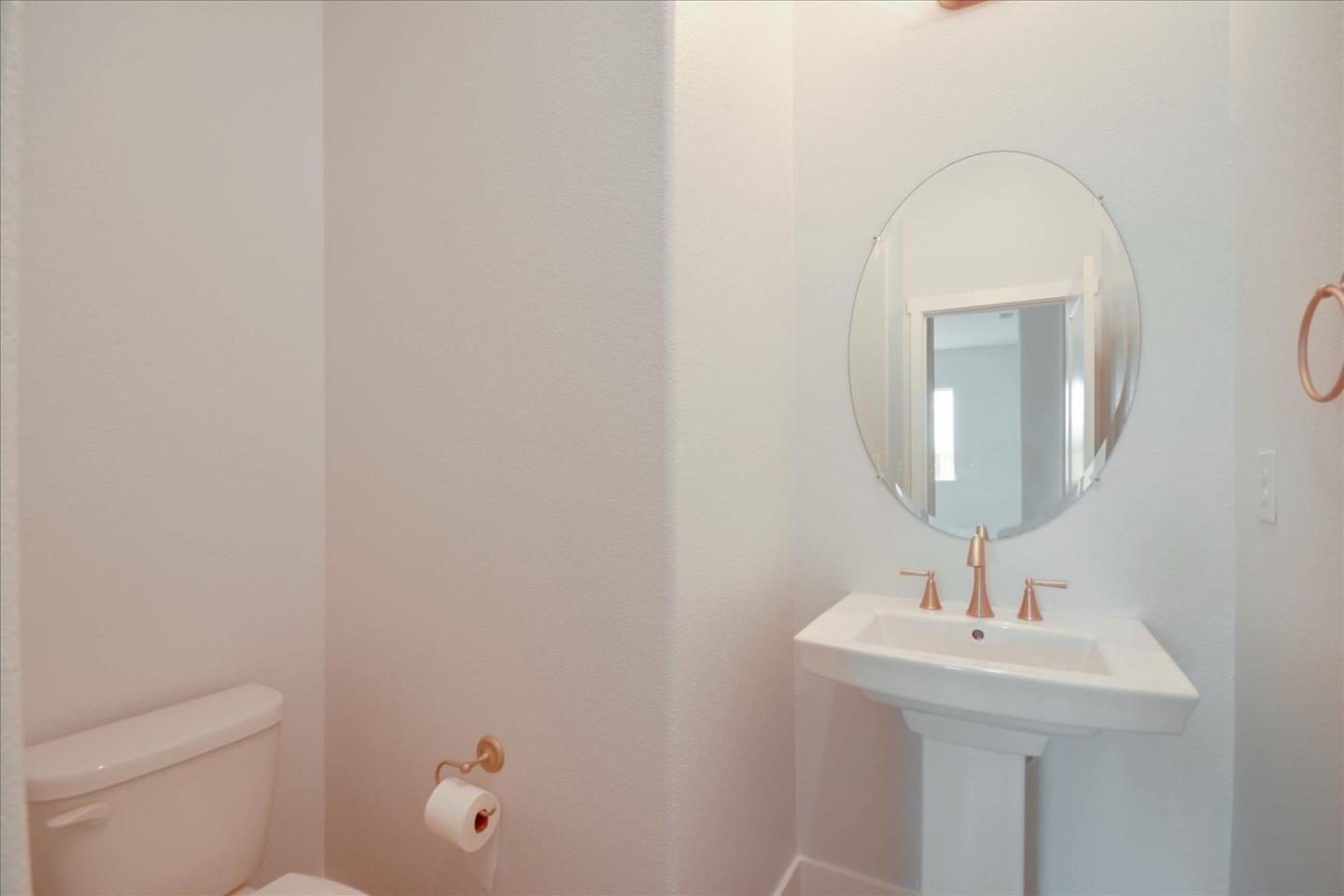 8157 Poppy Ridge Road Elk Grove, CA 95757 - Photo 28 of 42 a bathroom with a sink a toilet and mirror