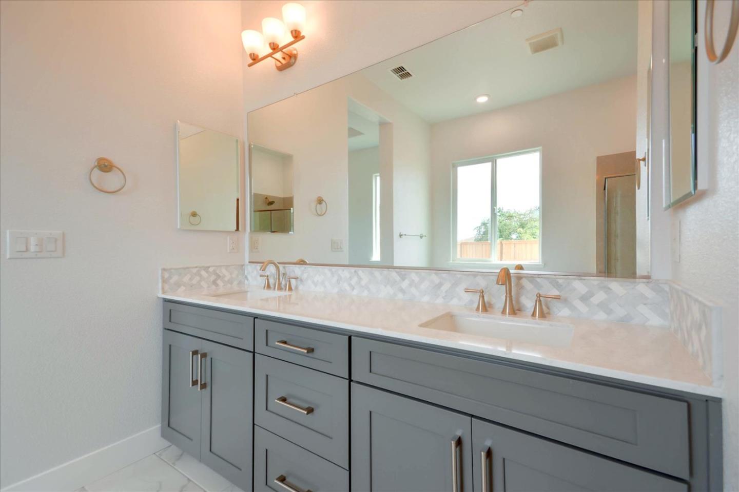 8157 Poppy Ridge Road Elk Grove, CA 95757 - Photo 32 of 42 a bathroom with a sink double vanity and a mirror