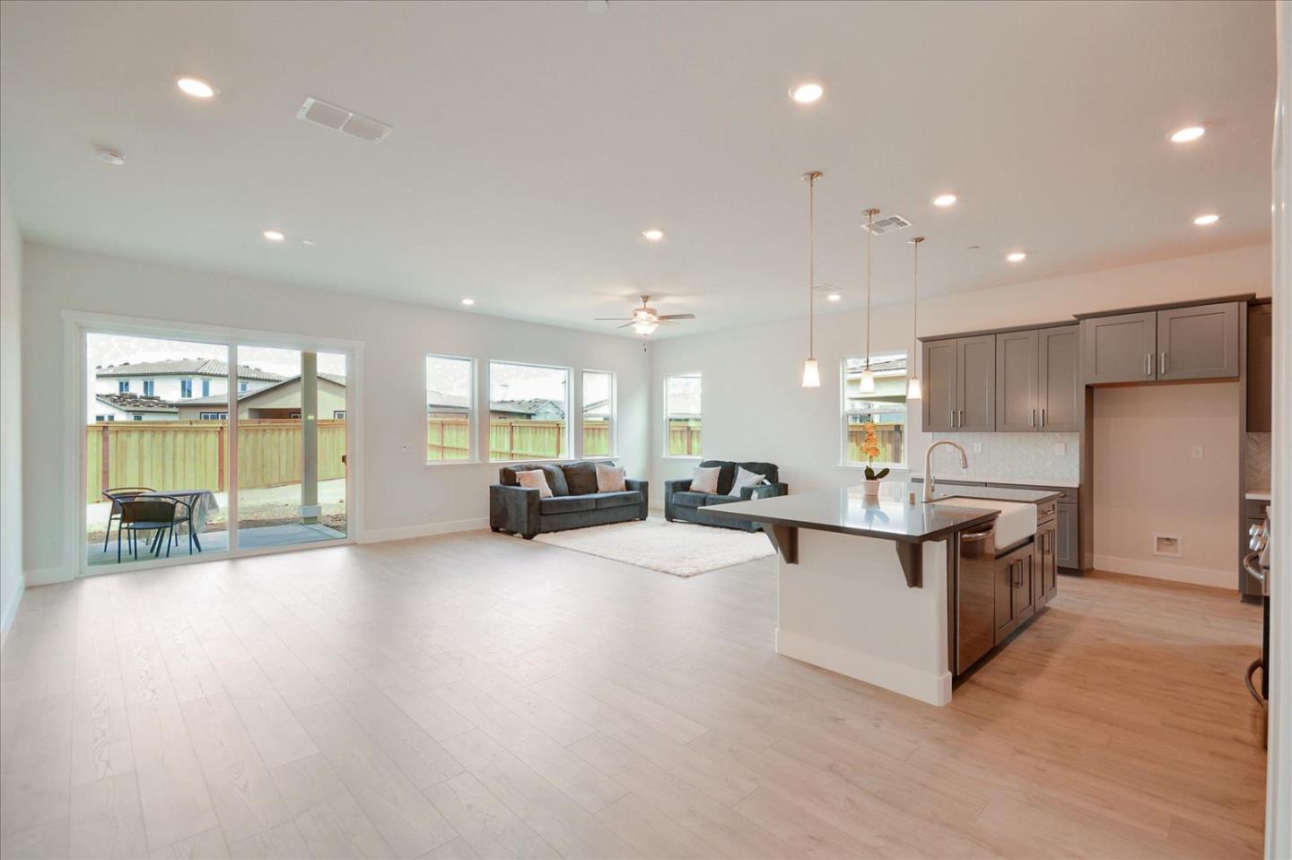 8157 Poppy Ridge Road Elk Grove, CA 95757 - Photo 8 of 42 a large kitchen with stainless steel appliances a large counter top and a wooden floors