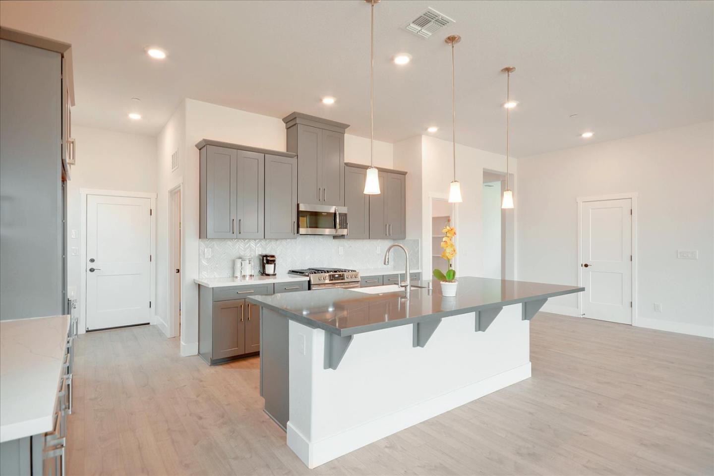 8157 Poppy Ridge Road Elk Grove, CA 95757 - Photo 10 of 42 a large kitchen with stainless steel appliances lots of white cabinets
