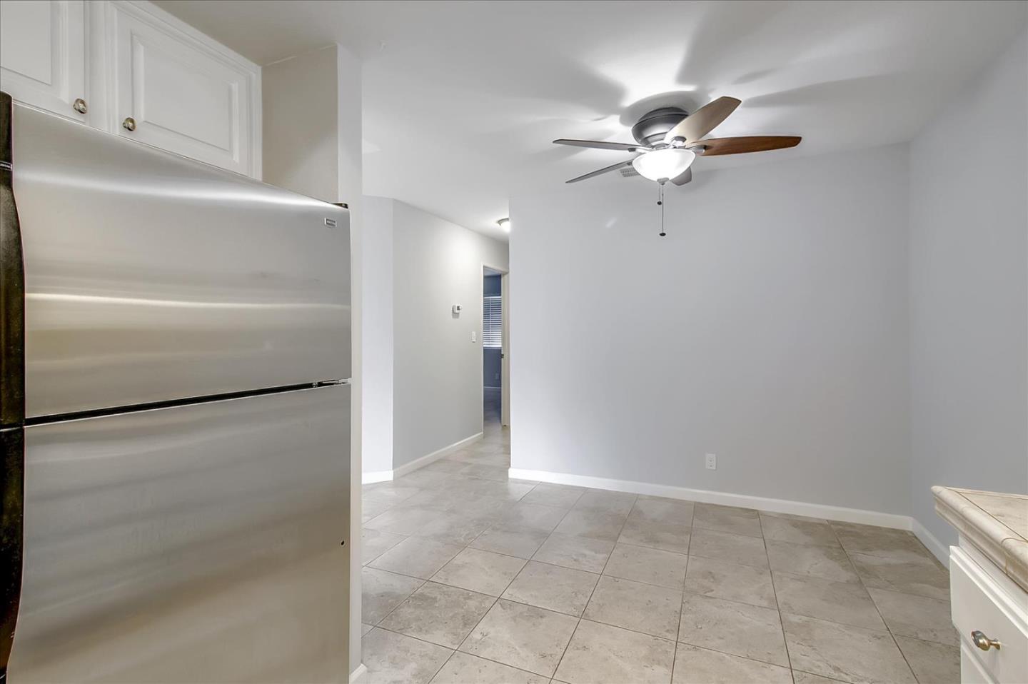 275 Shadow Dance Drive San Jose, CA 95110 - Photo 12 of 31 a view of a refrigerator in kitchen and cabinets