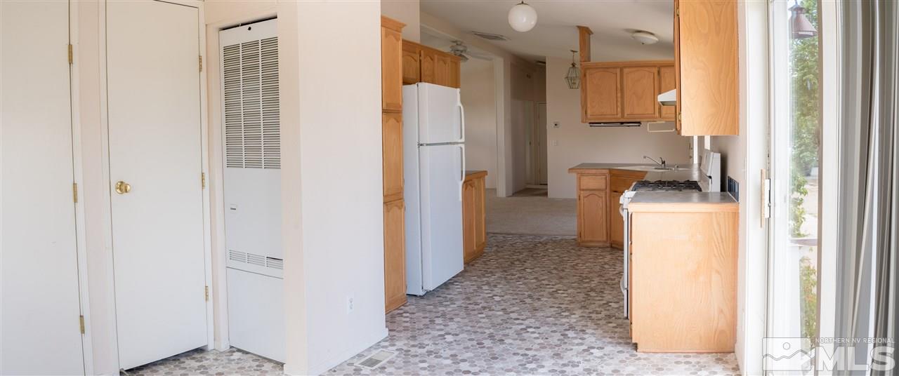 355 Magnolia Way Reno, NV 89506 - Photo 8 of 21 a view of a kitchen with furniture and a refrigerator