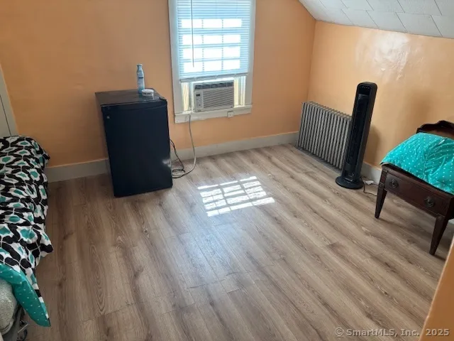 a view of wooden floor and windows in a room