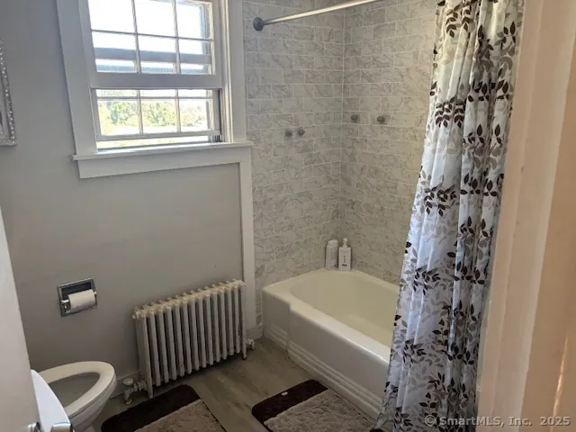 a bathroom with a bathtub and shower