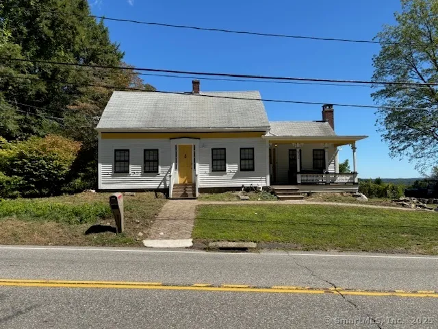 a front view of a house with a yard table and chairs