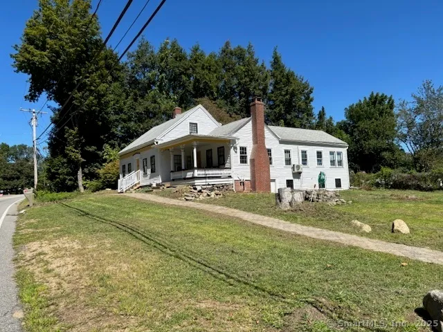 a front view of a house with a yard table and chairs