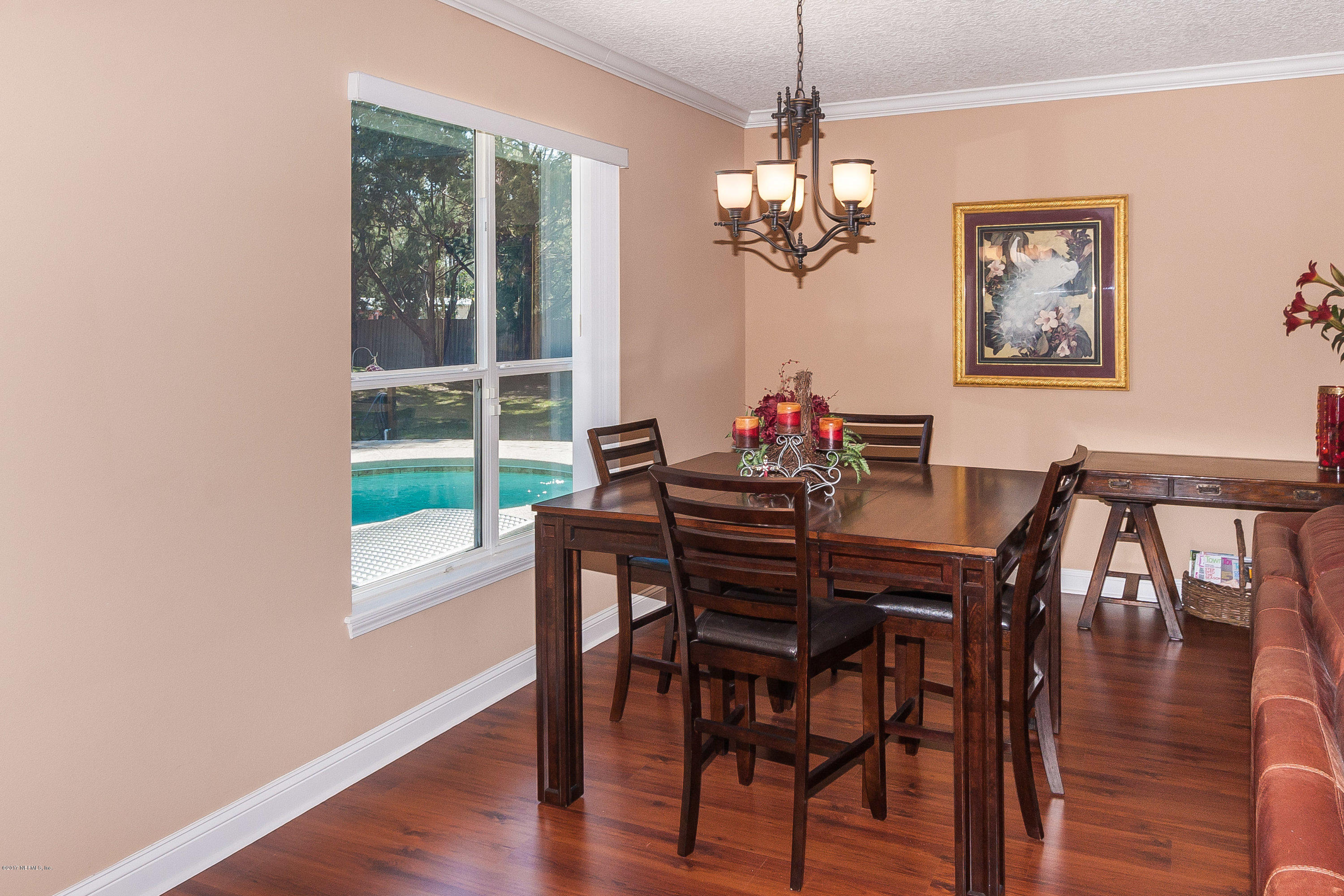 7713 Palmo Fish Camp Road St. Augustine, FL 32092 - Photo 11 of 35 a view of a dining room with furniture a chandelier and wooden floor