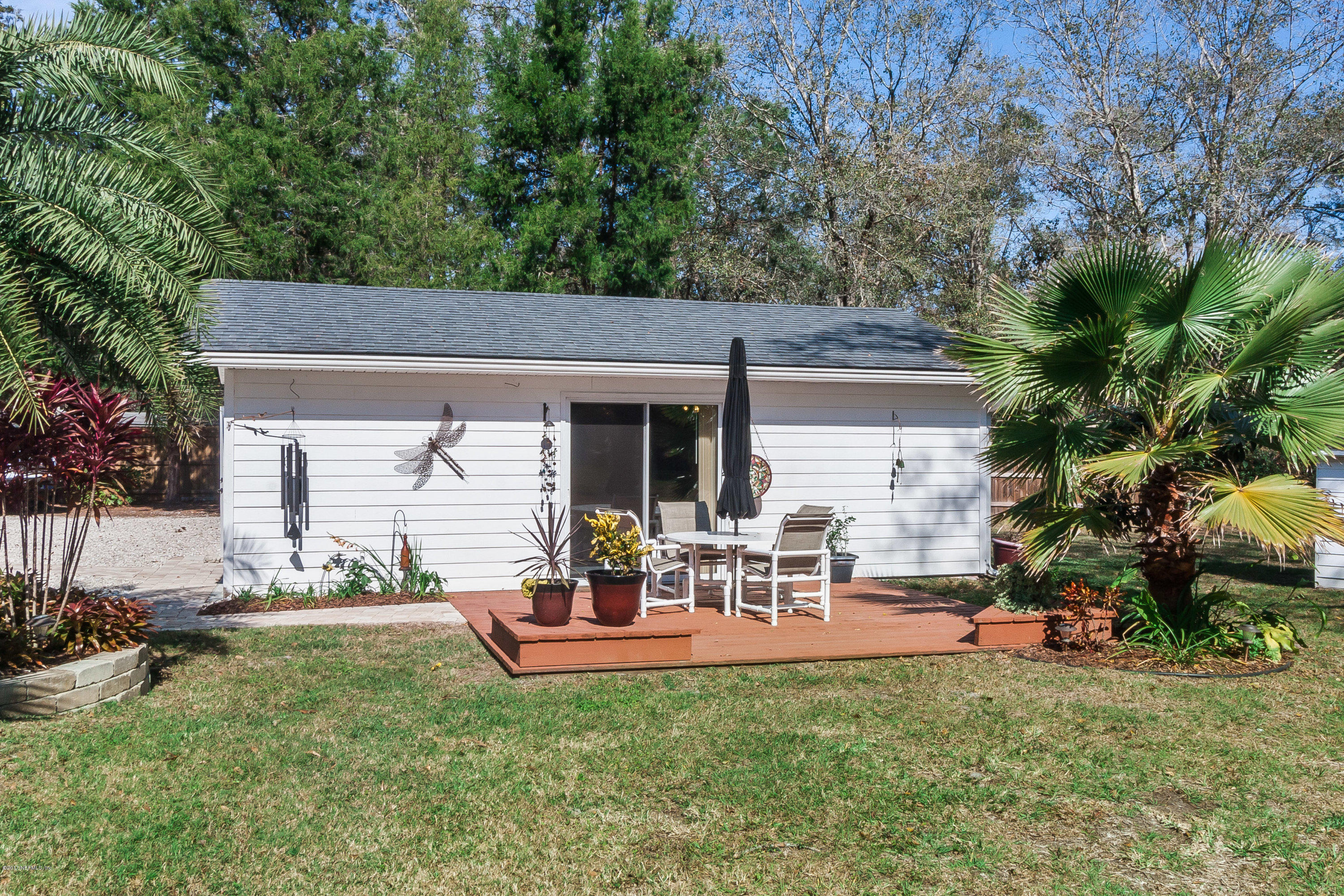 7713 Palmo Fish Camp Road St. Augustine, FL 32092 - Photo 25 of 35 a view of a house with backyard sitting area and garden