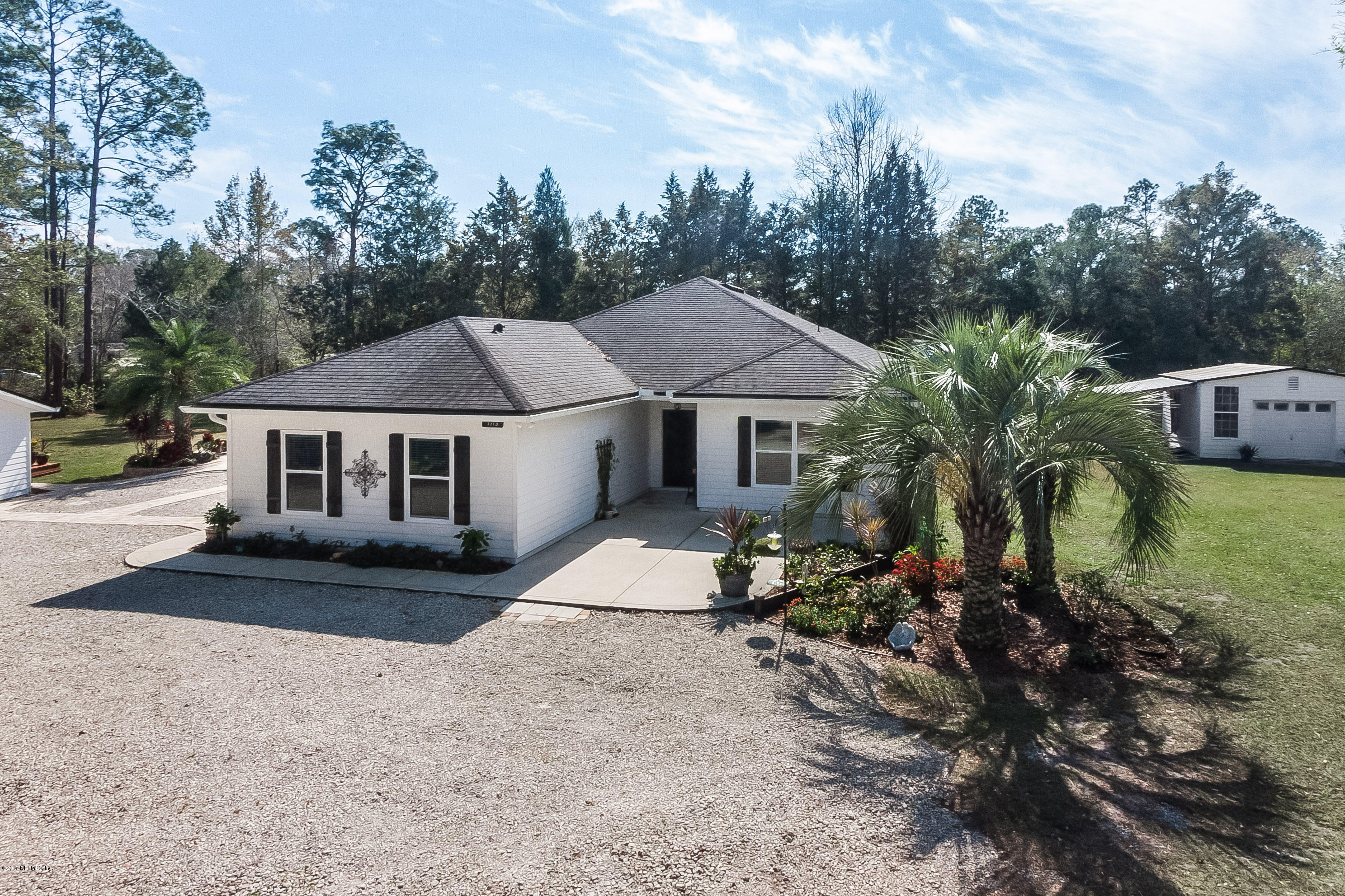 7713 Palmo Fish Camp Road St. Augustine, FL 32092 - Photo 3 of 35 a view of a house with a patio