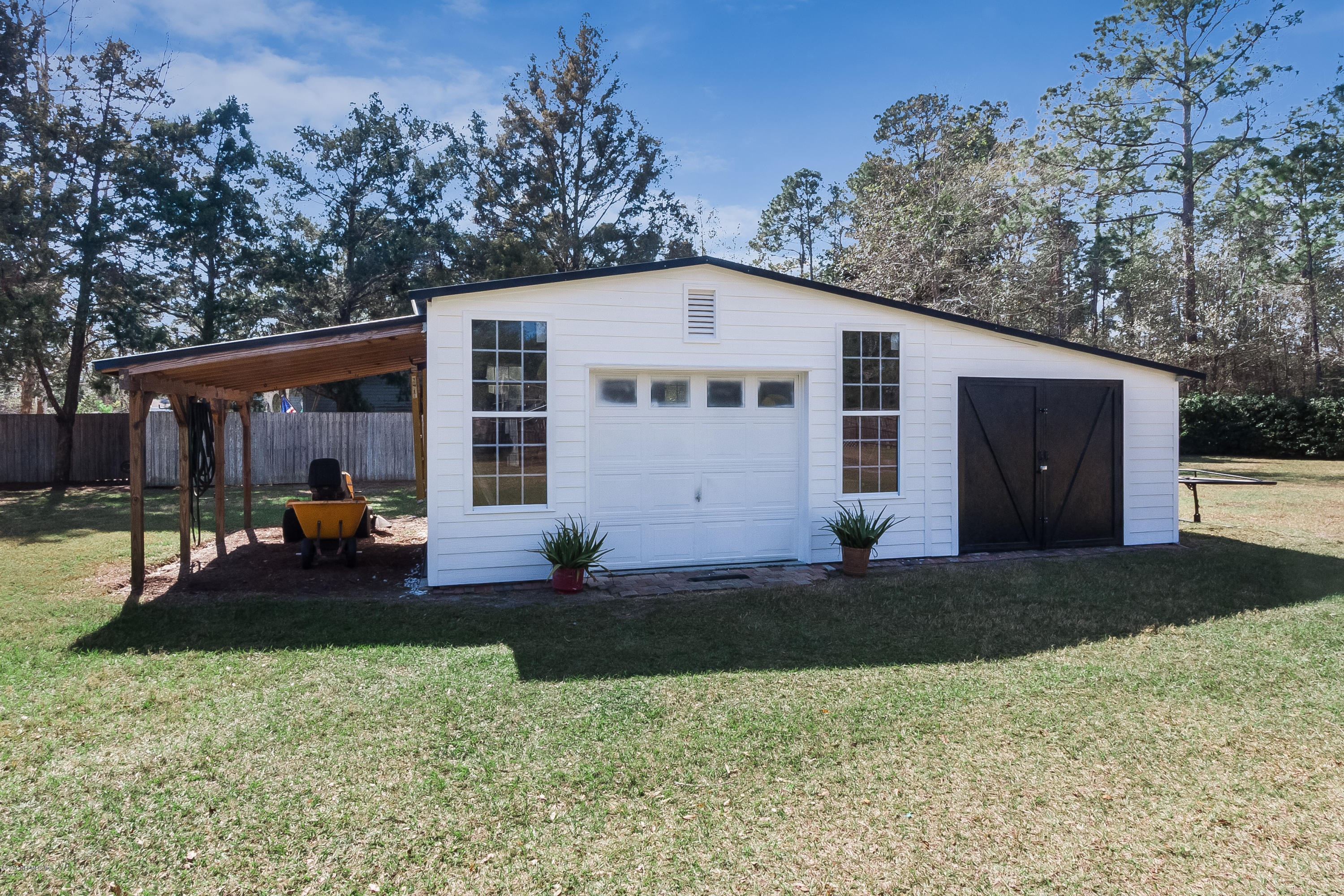 7713 Palmo Fish Camp Road St. Augustine, FL 32092 - Photo 31 of 35 a view of a house with backyard and trees
