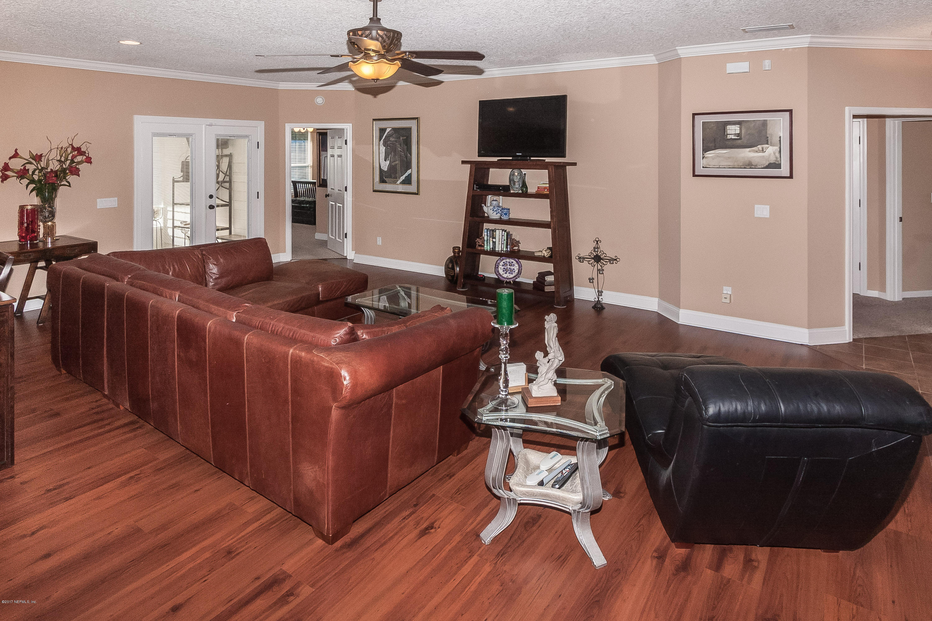 7713 Palmo Fish Camp Road St. Augustine, FL 32092 - Photo 7 of 35 a living room with furniture and a flat screen tv