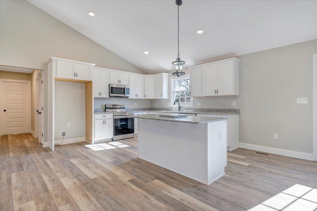 5934 Joppa Mill Road Moneta, VA 24121 - Photo 13 of 45 a large kitchen with stainless steel appliances granite countertop a lot of counter space and wooden floor