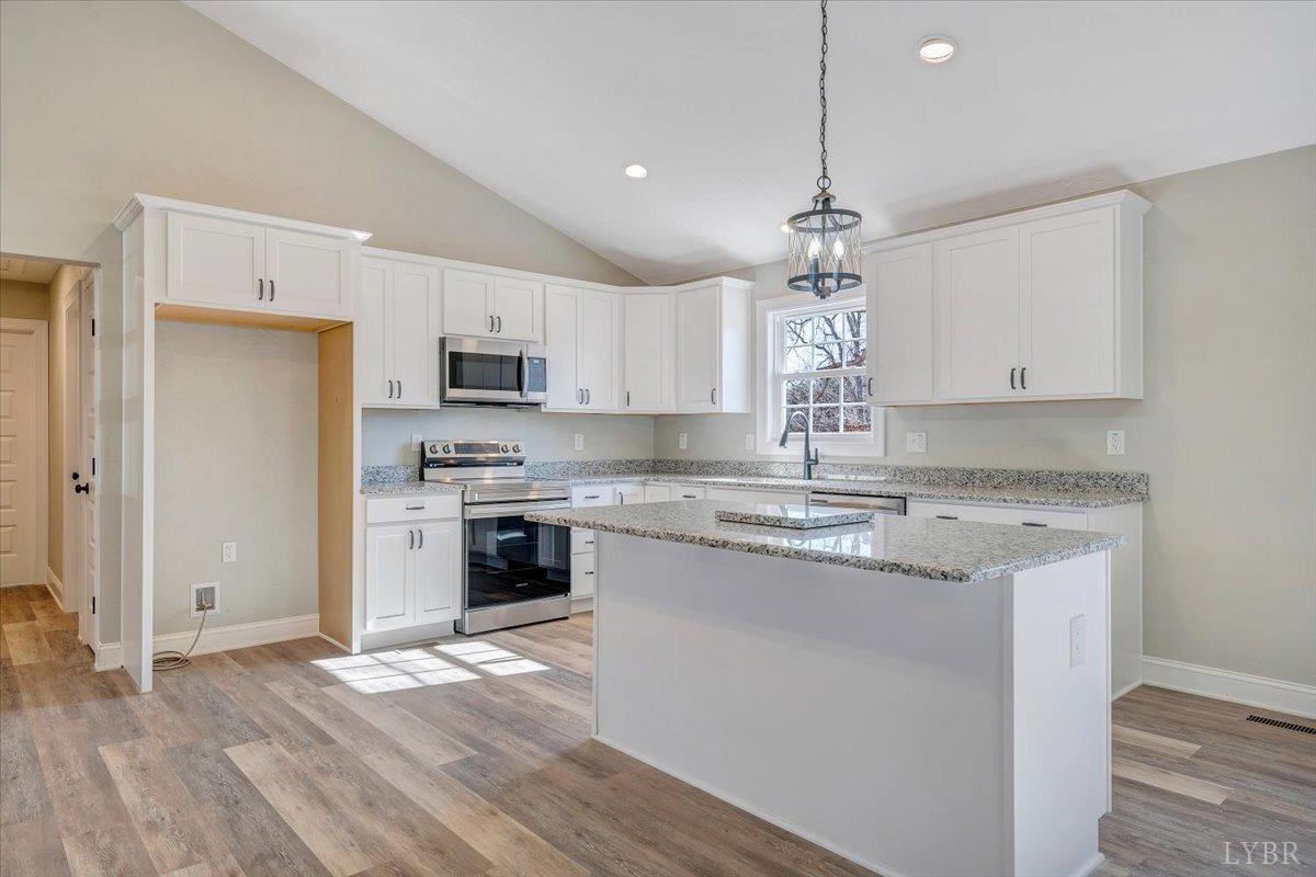 5934 Joppa Mill Road Moneta, VA 24121 - Photo 14 of 45 a kitchen with kitchen island granite countertop a sink cabinets and stainless steel appliances