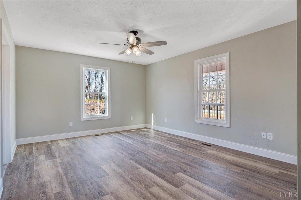 5934 Joppa Mill Road Moneta, VA 24121 - Photo 15 of 45 a view of an empty room with a window and wooden floor