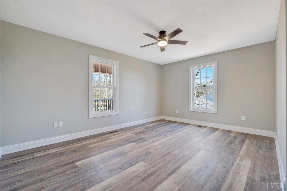 5934 Joppa Mill Road Moneta, VA 24121 - Photo 21 of 45 a view of an empty room with a window and wooden floor