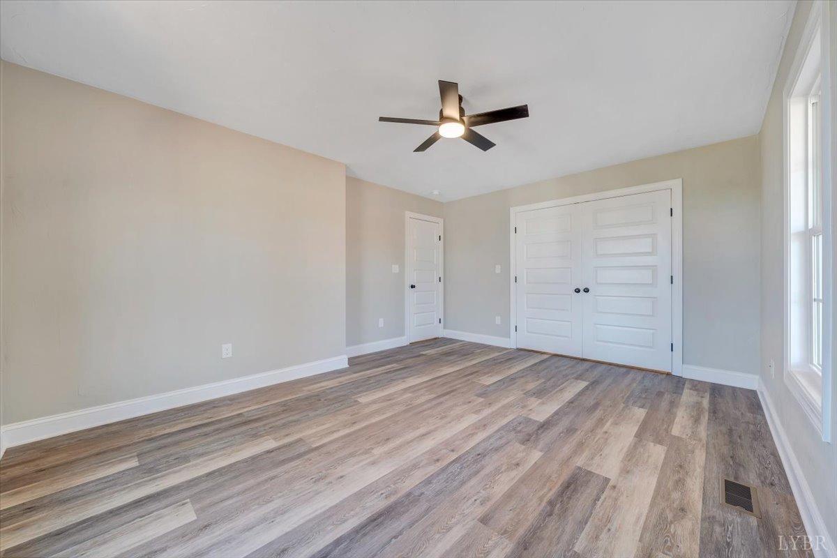 5934 Joppa Mill Road Moneta, VA 24121 - Photo 22 of 45 a view of empty room with wooden floor and ceiling fan