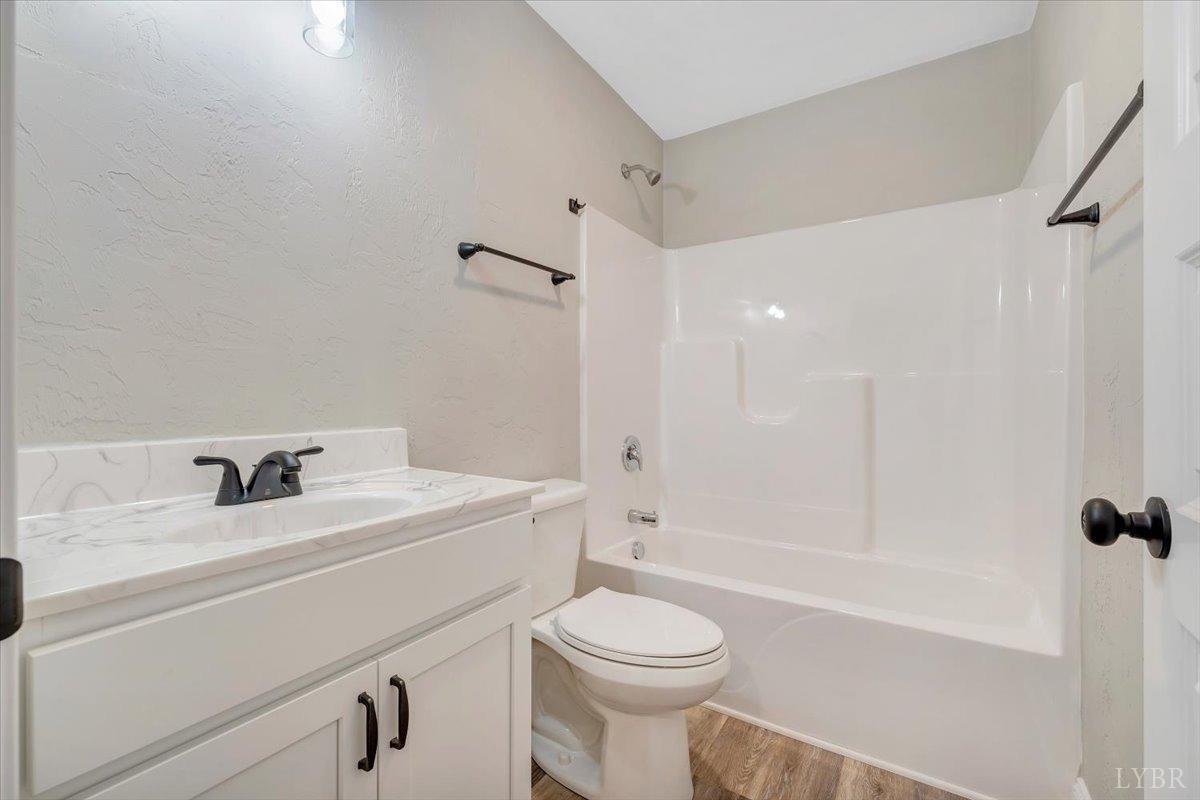 5934 Joppa Mill Road Moneta, VA 24121 - Photo 23 of 45 a bathroom with a sink a toilet and a bathtub