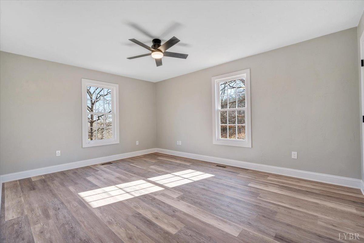 5934 Joppa Mill Road Moneta, VA 24121 - Photo 24 of 45 a view of an empty room with wooden floor and a window