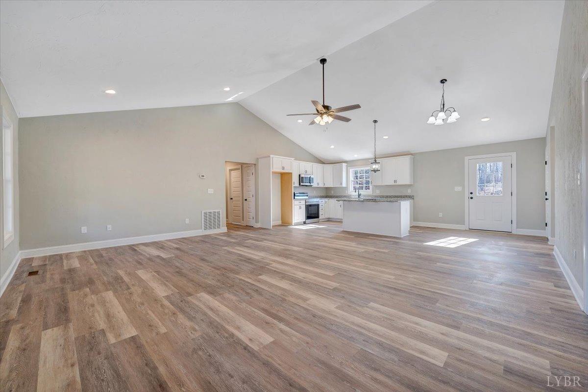5934 Joppa Mill Road Moneta, VA 24121 - Photo 3 of 45 a view of a kitchen with a dishwasher kitchen stove cabinets and wooden floor