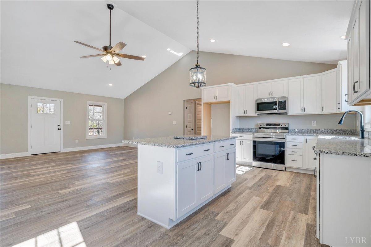 5934 Joppa Mill Road Moneta, VA 24121 - Photo 10 of 45 a large kitchen with granite countertop a stove top oven a sink a counter space and cabinets