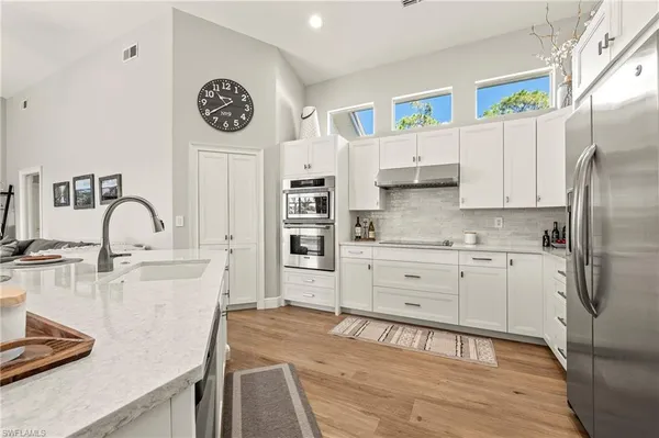 a kitchen with stainless steel appliances a stove a sink and a refrigerator