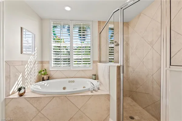 a bathroom with a bathtub and a shower