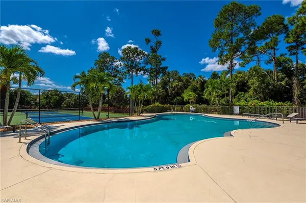 a view of a swimming pool with a yard