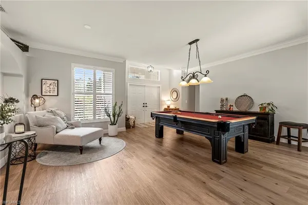 a living room with furniture a dining table and a chandelier