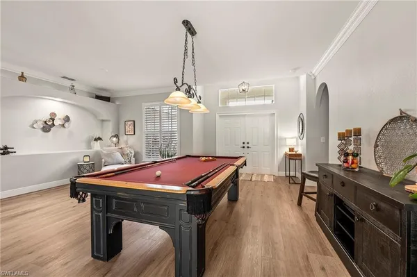 a kitchen with stainless steel appliances kitchen island granite countertop a stove a sink and a wooden floors