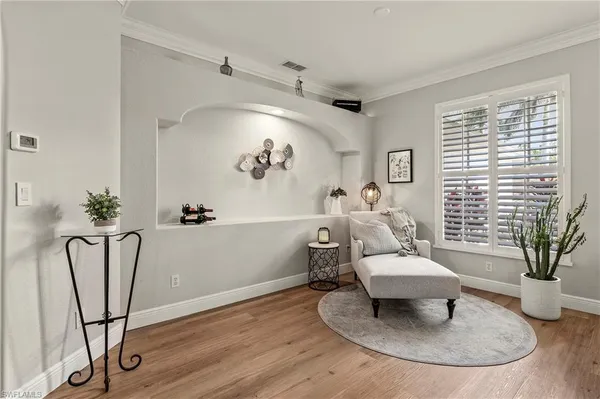 a living room with furniture and a potted plant