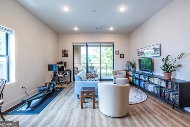 a living room with furniture and a wooden floor