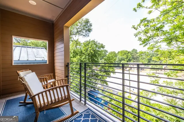 a view of a two chairs in the balcony