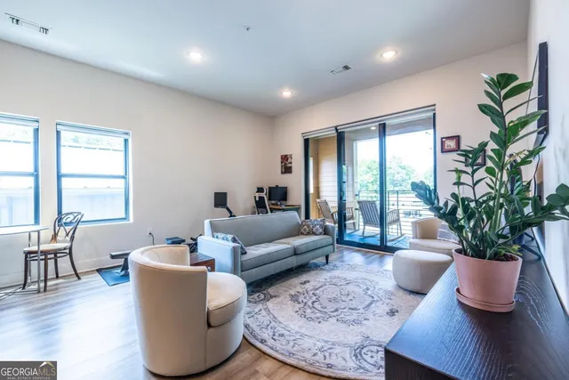 a living room with furniture potted plant and a window