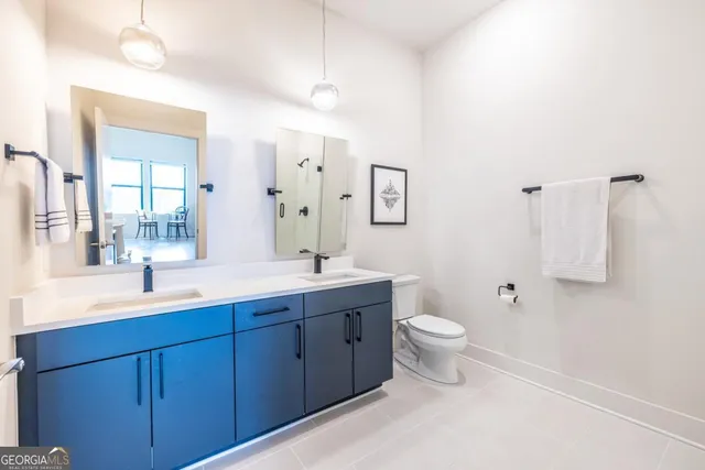 a bathroom with a toilet sink and mirror