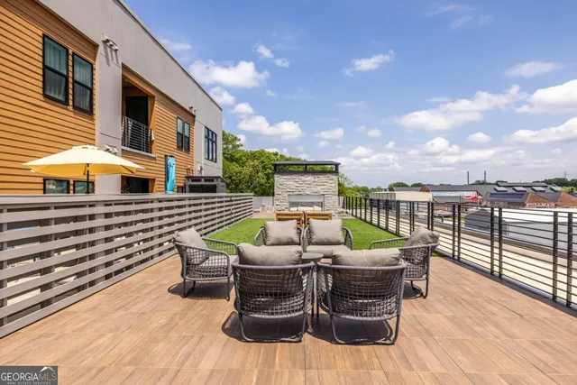 a view of a roof deck with furniture