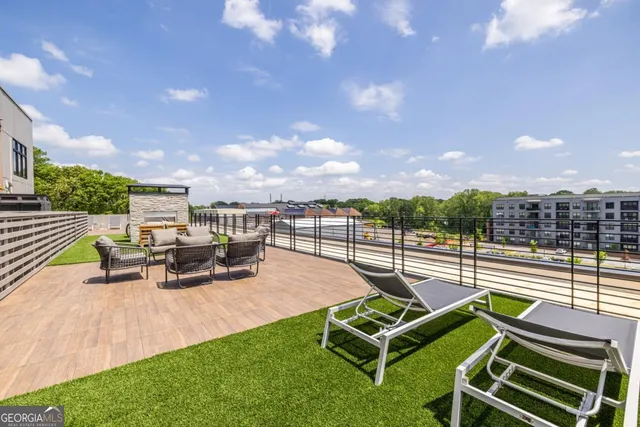 an outdoor sitting area with couch and a garden
