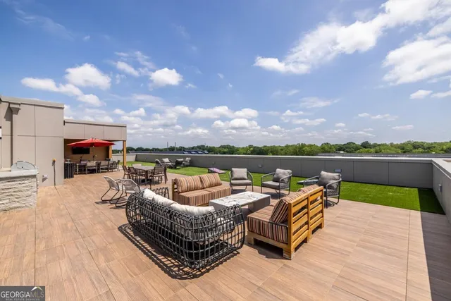 a roof deck with couches and wooden floor