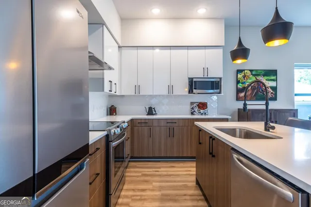 a kitchen with stainless steel appliances granite countertop a sink and cabinets