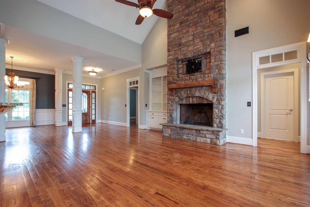7127 Old Franklin Road Fairview, TN 37062 - Photo 9 of 30 a view of a livingroom with wooden floor and a fireplace