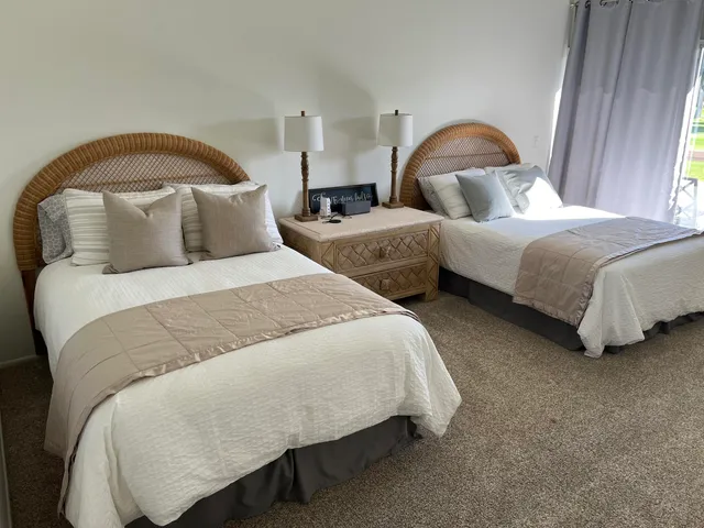 a bedroom with a bed and large flat screen tv