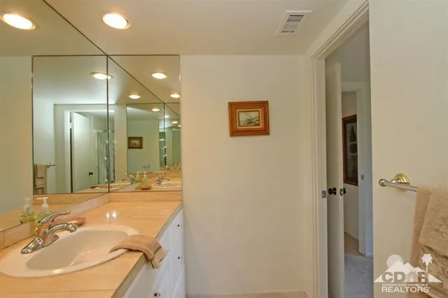 a bathroom with a tub sink and mirror