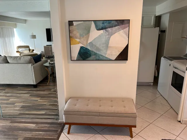 a bedroom with a bed and a flat tv screen on dresser