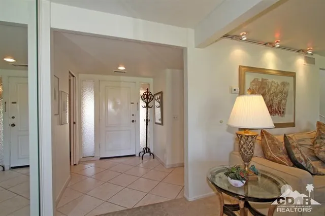 a view of a yard with a table and chairs under an umbrella