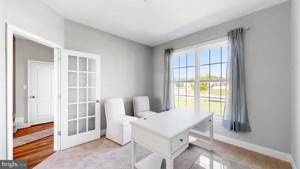 a view of a dining room with furniture and window