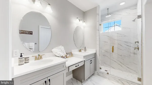 a bathroom with a double vanity sink mirror and shower