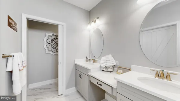a bathroom with a sink vanity and a mirror