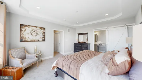 a spacious bedroom with a bed and a couch