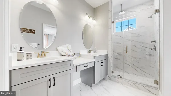 a bathroom with a double vanity sink mirror and shower