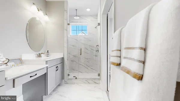 a bathroom with a double vanity sink mirror and shower